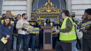 DCK6 Amazon Teamster Janee Roberts speaks at a rally outside San Francisco City Hall on December 16, 2025. 