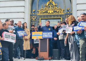 Joint Council 7 President Peter Finn speaks at a rally calling for AV accountability.